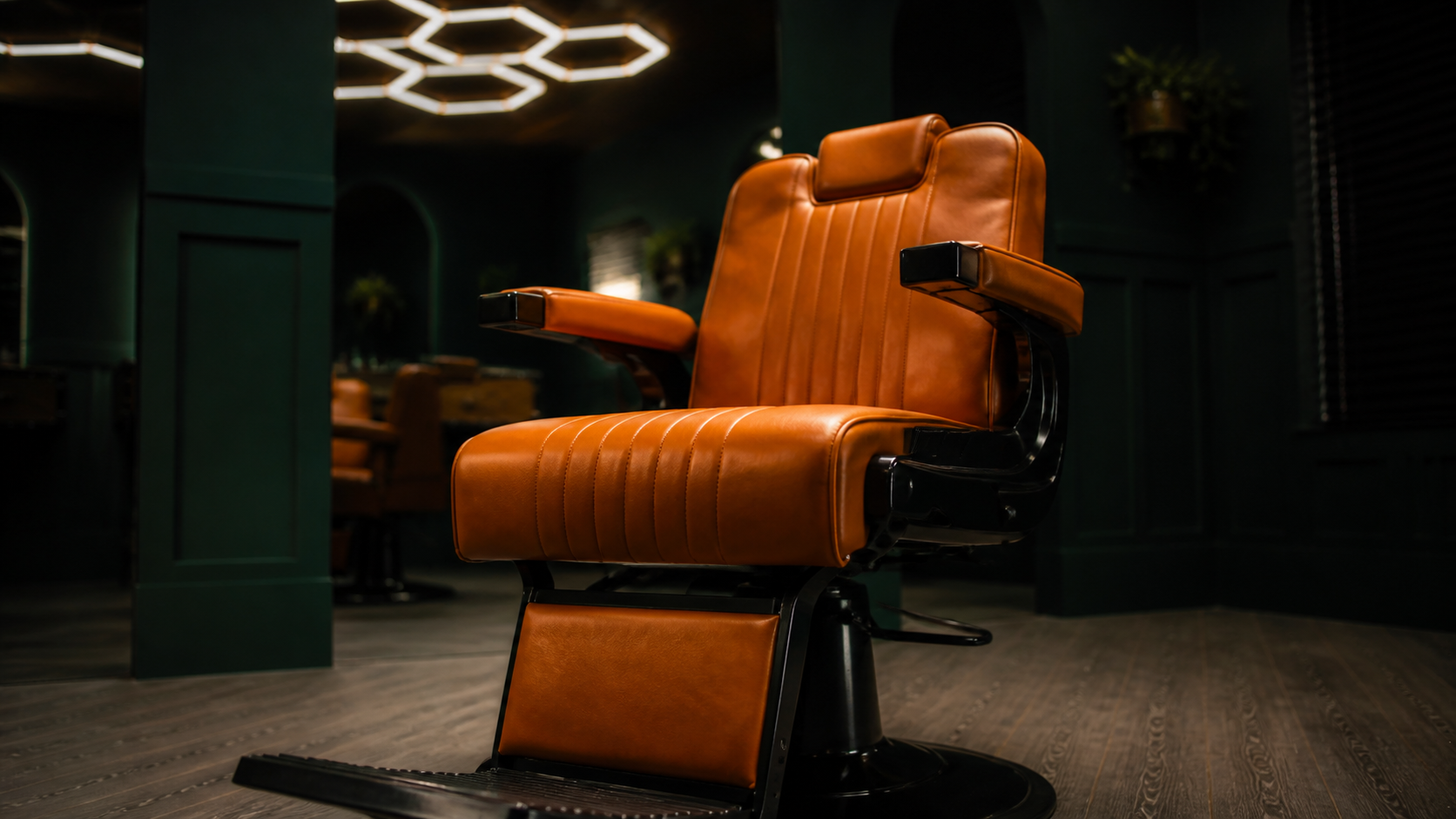 Orange leather barber chair in the JM Barber Co. studio